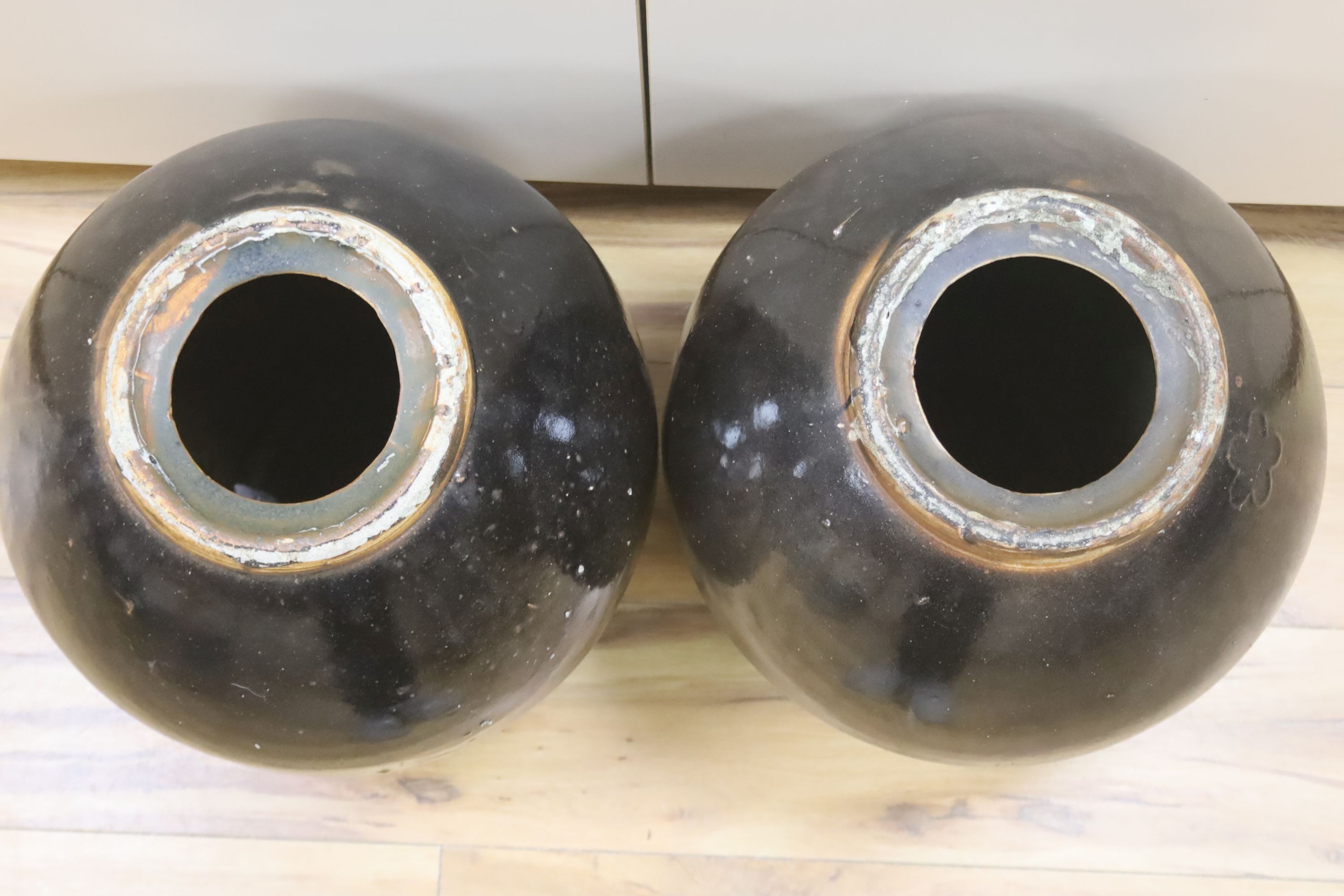 A pair of large monochrome brown glazed jars, height 40cm